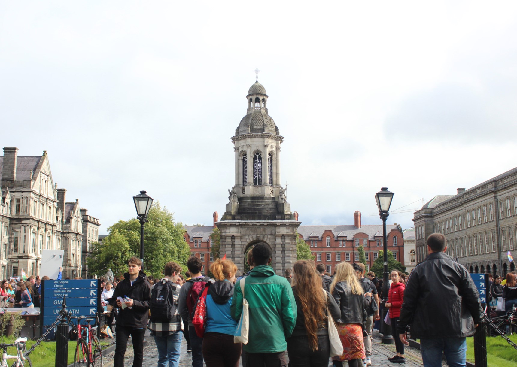 Students walking on the Front Square of campus with the Campanile in the background
